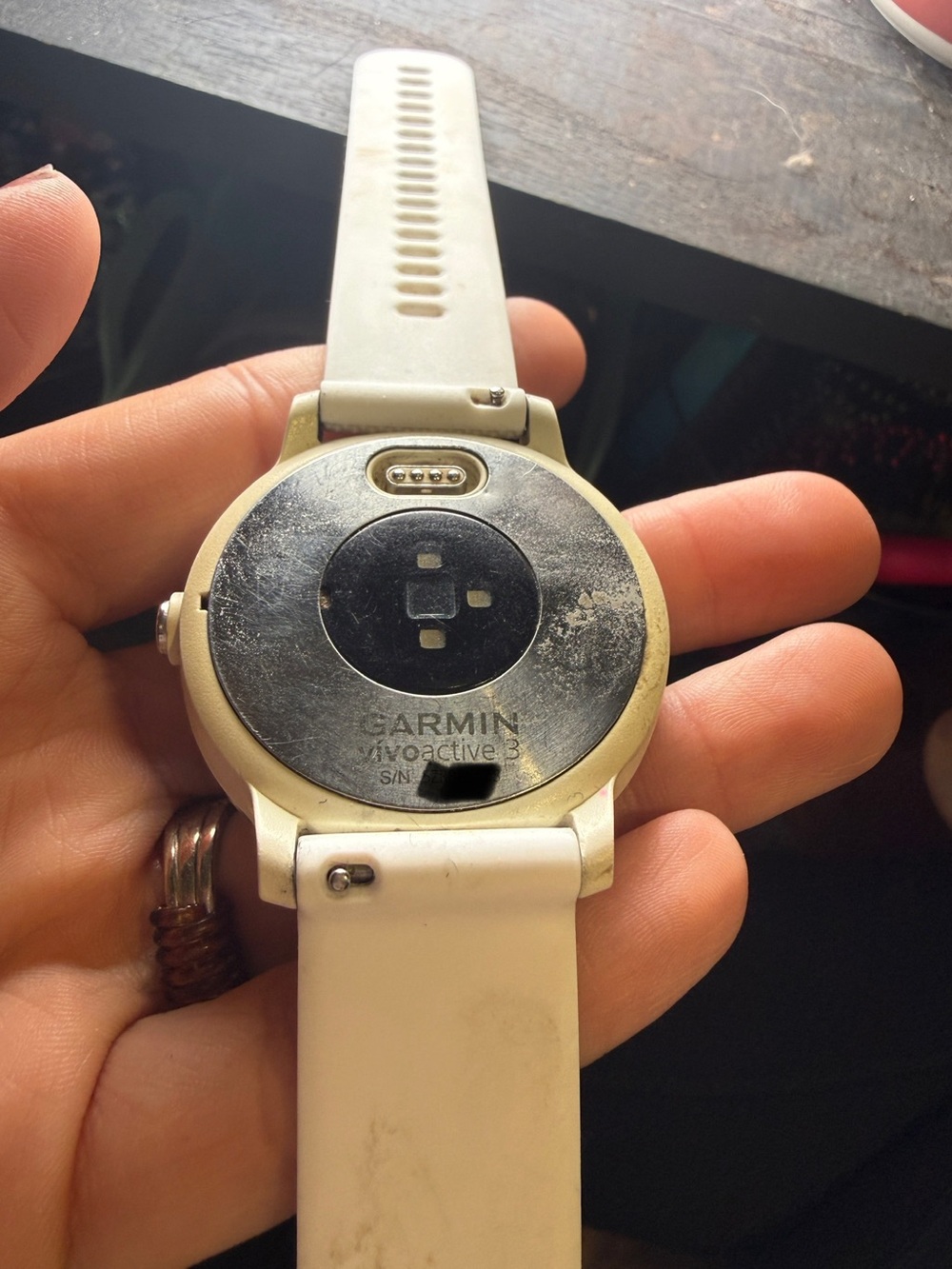 garmin white smartwatch with round stainless back